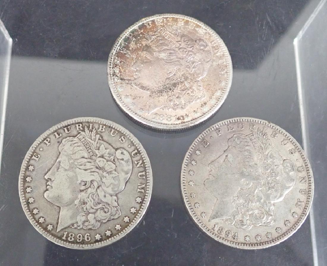 Morgan Silver Dollars 1896 O, 1894 O & 1881 S: Three Morgan silver dollar coins. Includes: loose 1896O & 1894O & and 1881S. ($1, money, collecting, Numismatics, currency, eagle, E Pluribus Unum) STERLING ASSOCIATES STRIVES TO PROVIDE ACCURATE, OBJ
