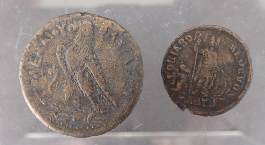 Two Ancient Coins, Roman & Ptolemaic Empires: 2 coins from ancient empires. Includes: - Ptolemaic Empire coin. - Roman Empire Coin. Age, wear. (money, collecting, Numismatics, currency) STERLING ASSOCIATES STRIVES TO PROVIDE ACCURATE, OBJECTIVE, 