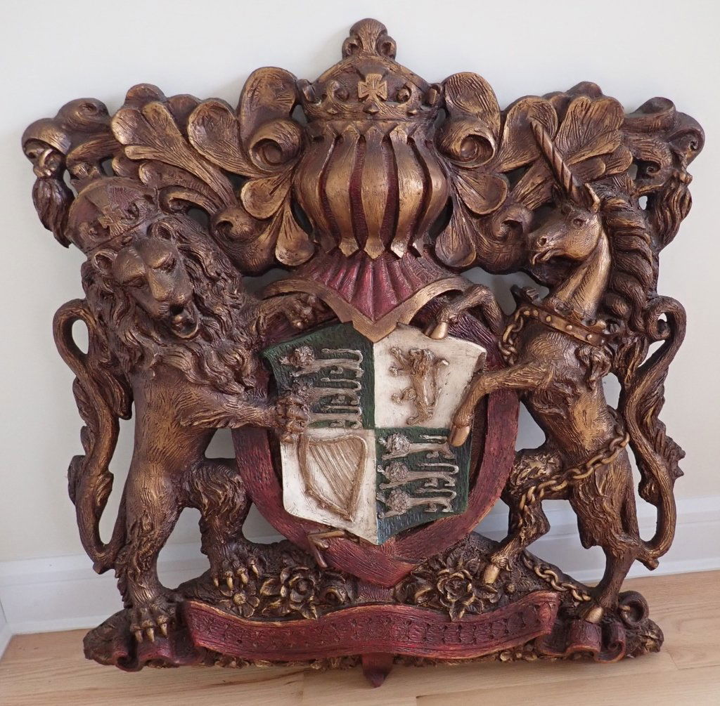 Mid-Century Finesse Originals Cast Coat of Arms: Finesse Originals Cast Fiberglass Lion & Unicorn Crest. Decorative, wall hanging by Finesse Originals, circa the 1970s. Mid Century Modern. Height: 40"; Width: 39"; Depth: 4 1/4". Imperfections.STERLI