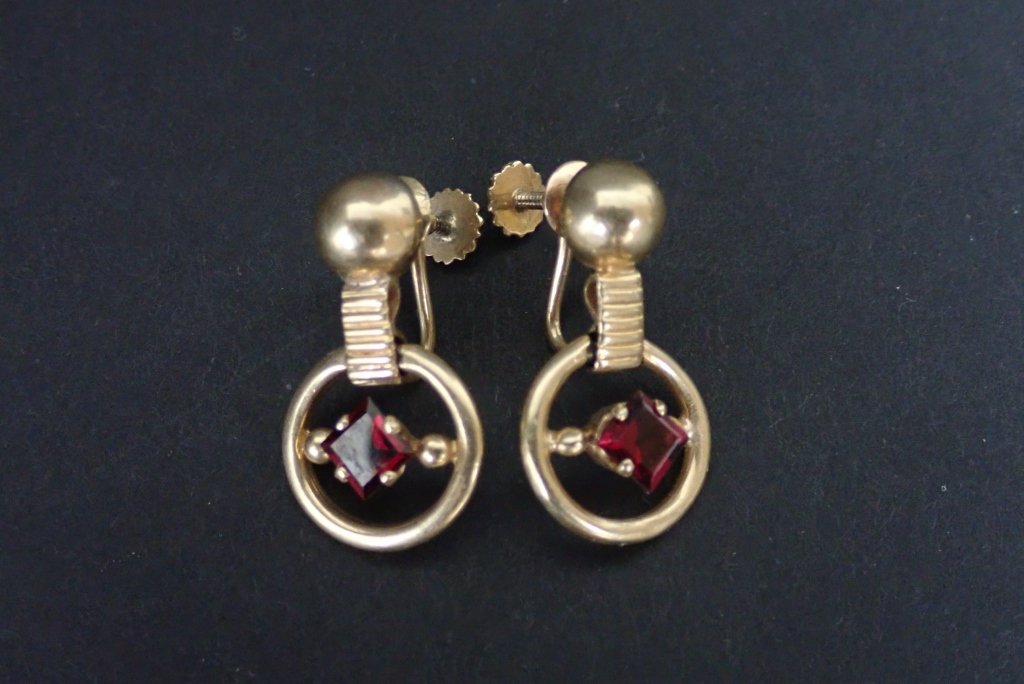 Gold & Ruby Earrings Signed Tiffany: Pair of ruby and 14k yellow gold screw back earrings.Backs marked 14k Tiffany.Length: 1". Total approximate weight: 7.6 grams. STERLING ASSOCIATES STRIVES TO PROVIDE ACCURATE, OBJECTIVE, & FAIR INFORM