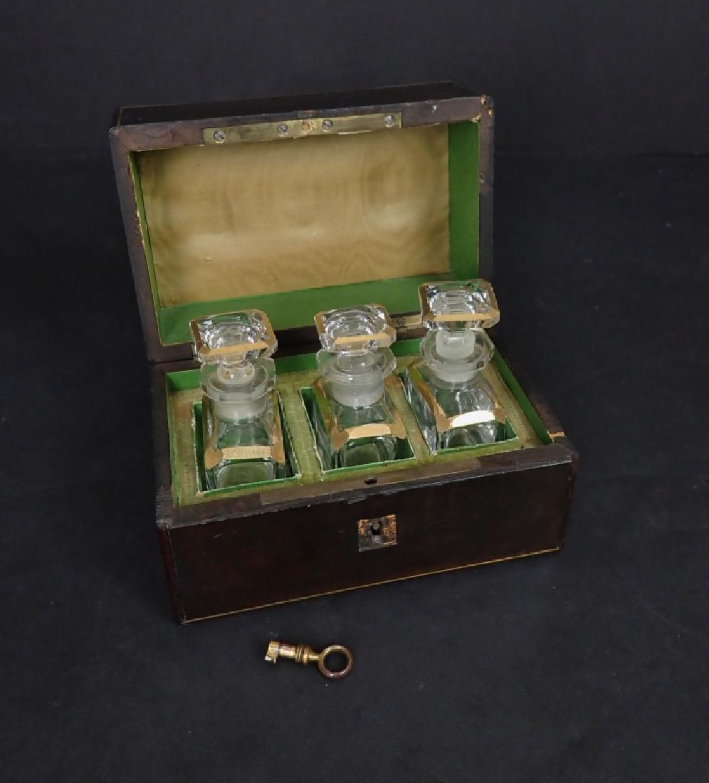 Vintage Glass Ink Bottles in Inlaid Wood Box: Three gilt accented vintage glass bottles with stoppers in a lined inlaid wood box. Box includes key. Imperfections to box & bottles. One stopper is stuck. Box height: 3 1/2"; Width: 5 1/4"; Depth: 3 