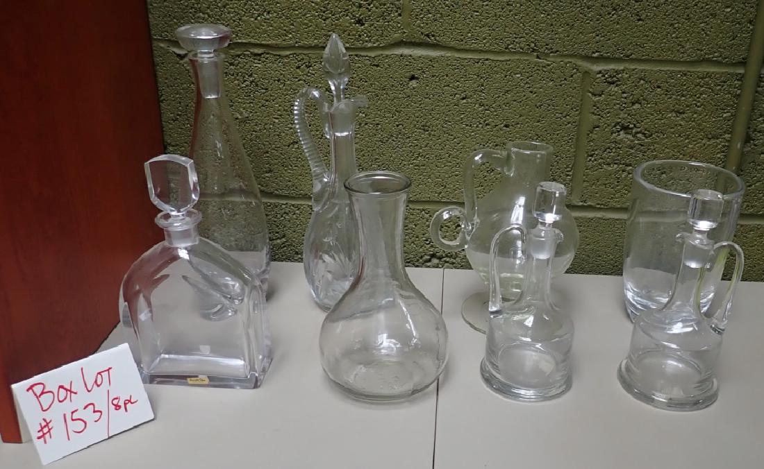 Box Lot #153 Clear Glass Decanters, Vases +: 8 piece lot includes: -Orrefors decanter with stopper. Maker's label sticker on bottom edge. Signed on bottom: orrefors M 2495/111. Total Height: 9 1/4", vinegar and oil pitchers with stoppers, Vases 