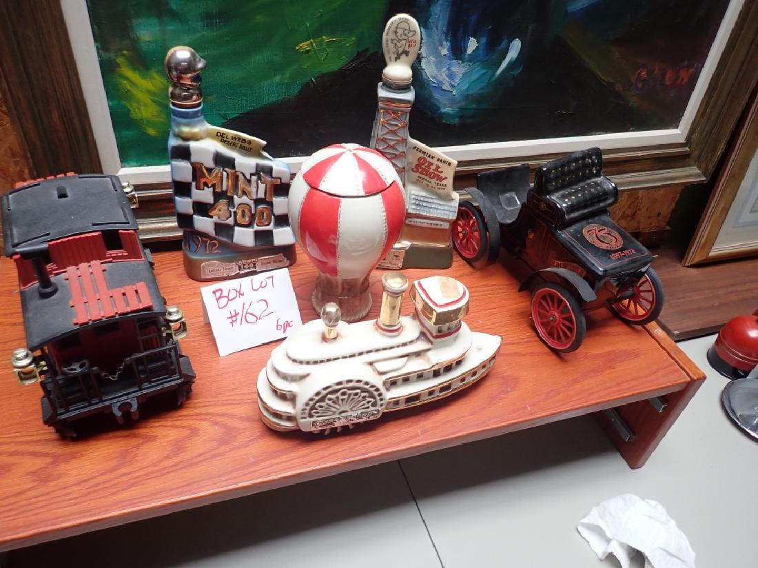 Box Lot #162 Vintage Ceramic Liquor Decanters: 6 piece lot includes: - Jim Beam Odessa Texas Oil Show Decanter The Oil Field Workers Show - Jim Beam Decanter Mint 400 1972 Del Webb Desert Rally Las Vegas - Delta Belle ship decanter Ezra Brooks - C