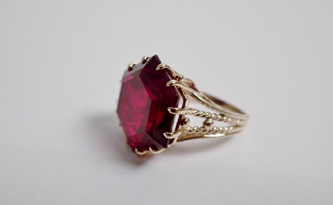 14k Gold & Ruby Ring: Synthetic Ruby stone is set in 14 karat yellow gold. 4.95 DWT; 7.7 grams. Approximate ring size: 5 1/2 (see photos). Height: 1". (jewelry, fashion, accessory) STERLING ASSOCIATES STRIVES TO PROVIDE AC