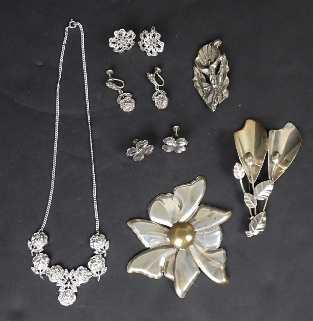 Sterling Silver Floral Jewelry Assortment: Collection of vintage floral design silver jewelry. Includes 3 pins, 3 pairs of screw-back earrings and a necklace. All pieces marked sterling. Total approximate weight: 93 grams. Necklace Length: 8 1