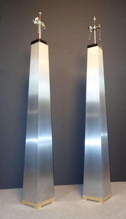 Brushed Metal Obelisk Form Floor Lamp Pair: Set of two tall obelisk lamps in brushed metal. Each features a 2-light fixture. Height to finial: 64". Height to top without fixture: 53"; Width: 7 1/4"; Depth: 7 1/4". (lighting, interior design, mo