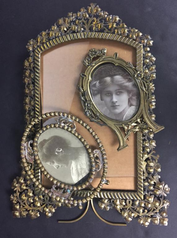 Collection of Three Antique Picture Frames: Three ornate picture frames. Two smaller oval frames and one larger frame with a curved top edge. Oval frame with profile image height: 7"; Width: 5 1/4". Larger frame height: 15 1/4" x 11 3/8". STERL