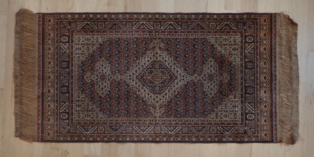 Antique Small Silk Prayer Rug: Small fringed throw rug with geometric pattern with border. Fringed ends. Possibly silk. No labels. Length including fringe: 55 1/2"; Width: 25 1/4". (Persian rug, prayer rug) STERLING ASSOCIATES STRI