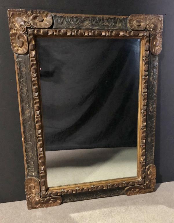 Mediterranean Carved Ebonized & Gilt Wood Mirror: Carved wood mirror. Height: 48"; Width: 36"; Depth: 2". Imperfections. STERLING ASSOCIATES STRIVES TO PROVIDE ACCURATE, OBJECTIVE, & FAIR INFORMATION ON ALL LOTS. WE WILL BE HAPPY TO ANSWER ANY QUESTI