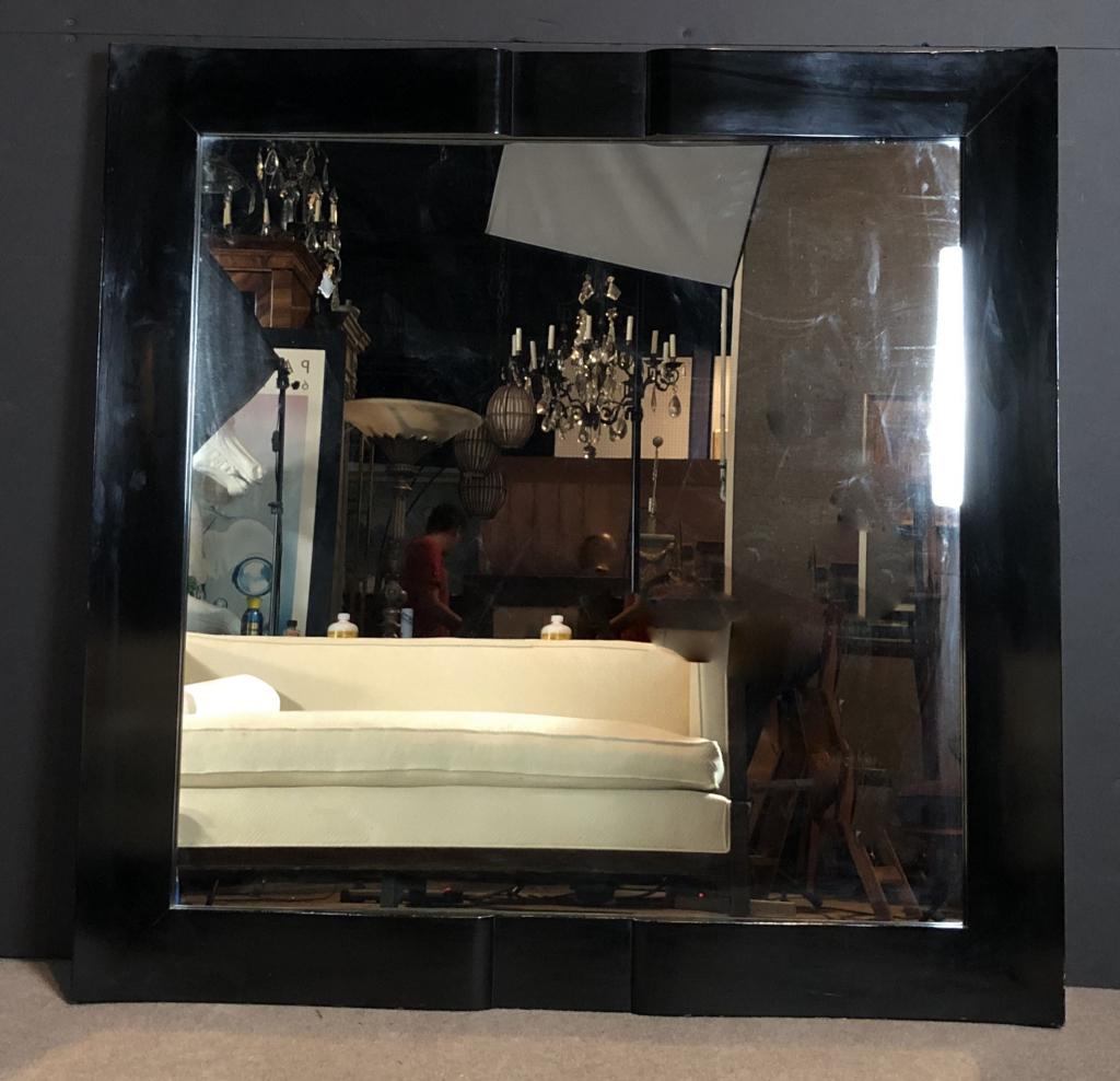 Large Black Lacquered Mirror by James Mont: James Mont branded black lacquer square wall mirror. Imperfections. Height: 47 3/4"; Width: 47 3/4". STERLING ASSOCIATES STRIVES TO PROVIDE ACCURATE, OBJECTIVE, & FAIR INFORMATION ON ALL LOTS. WE WILL
