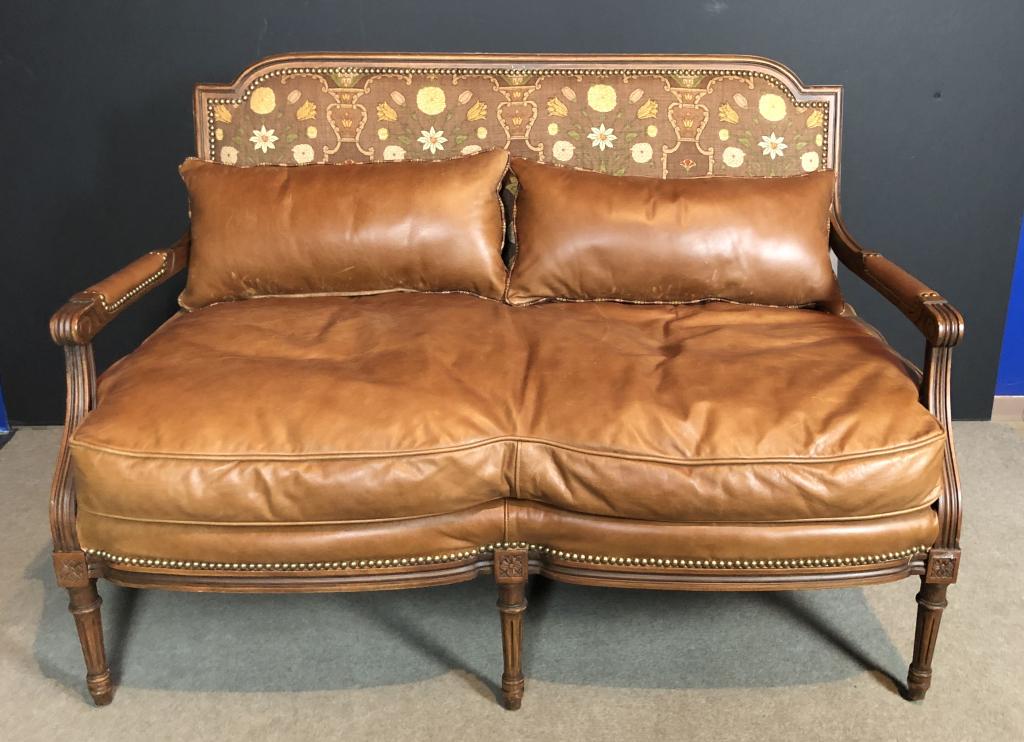 Leather & Upholstery Settee, Old Hickory Tannery: Old Hickory Tannery leather settee with upholstered back. Carved column legs. Nail Head detail. Two matching pillows. Height: 36"; Width: 51 1/2"; 28". Seat height: 20". (furniture, seating, interior 
