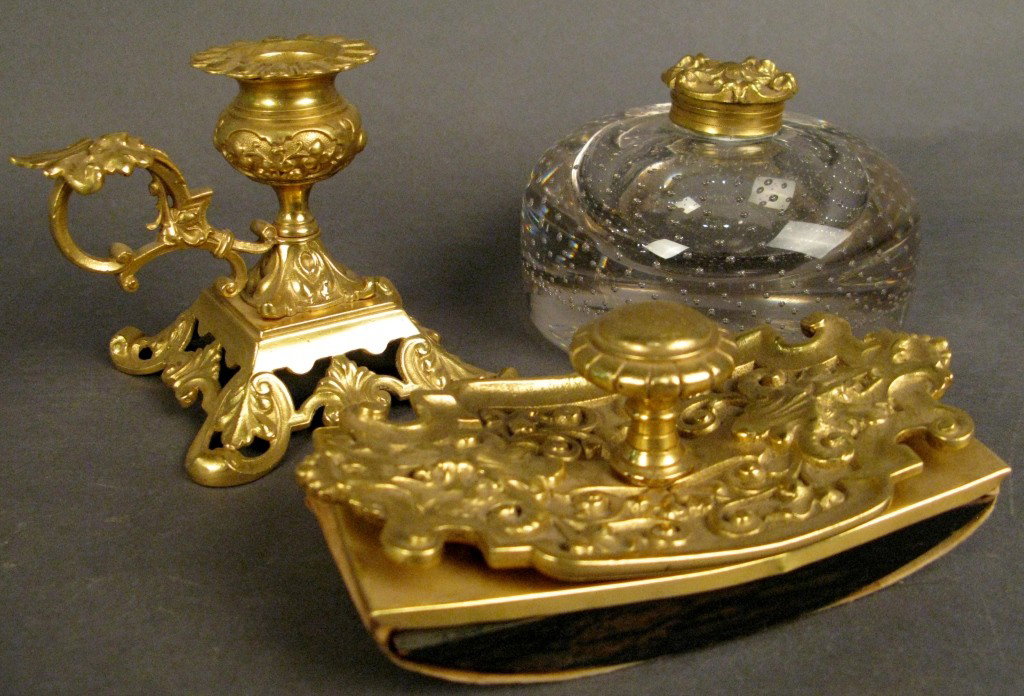 Doré bronze desk set: 3 piece doré bronze desk set, Inkwell, candle stick, & ink press Glass vessel has hinged top Inkwell: 3"T, 5" diameter Candle stick: 3 7/8"T Press: 6"L