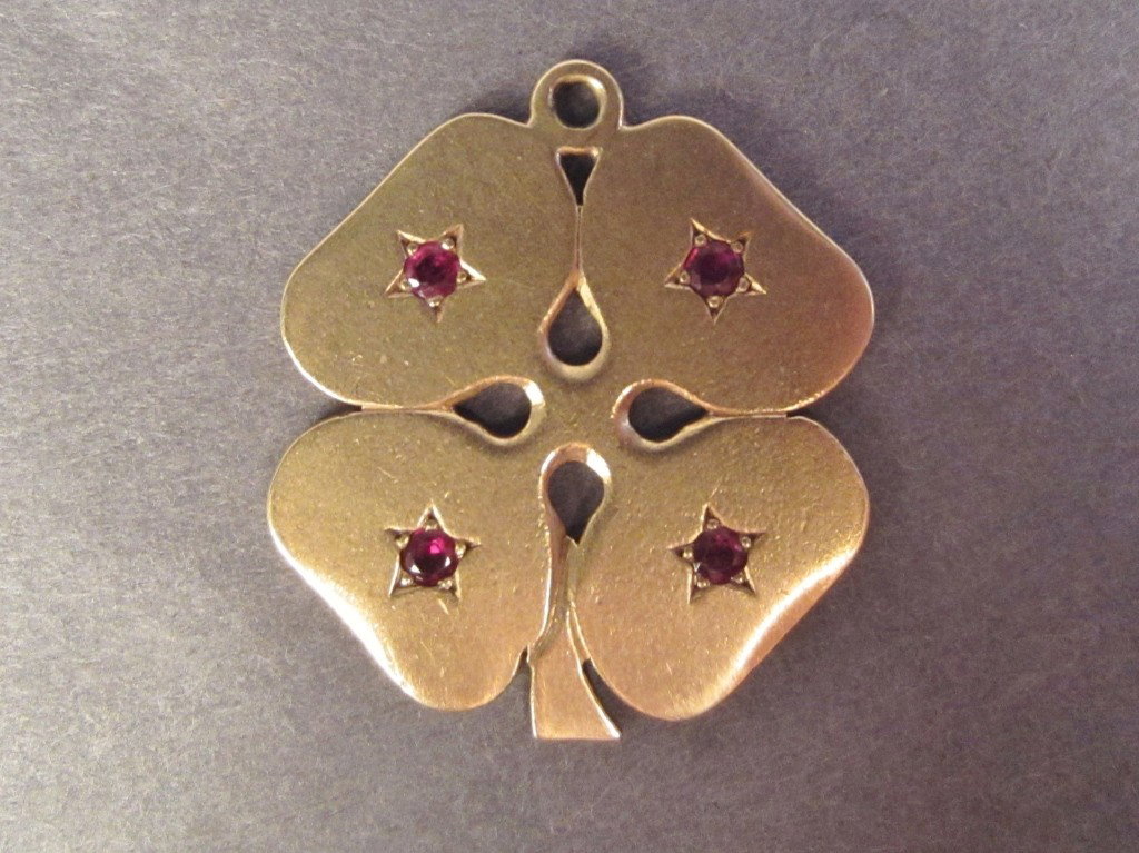 Cartier, 14kt Charm: Cartier 14 karat four leaf clover motif charm with 4 garnets Height: 1"