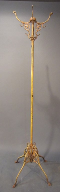 Free Standing Victorian Iron Coat Rack: Victorian figural free standing iron coat rack, griffin heads and bird feet, original paint. Height: 66", Width: 22"