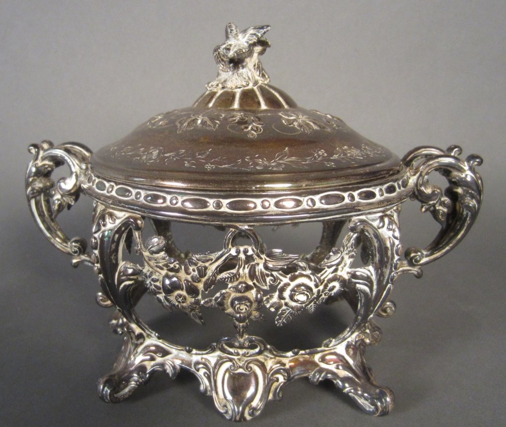 Coin Silver Covered Frame: Coin silver covered frame with scroll handles. Repousse floral lid has decorative bird finial. Continental 19th Century. missing glass insert Height: 5 3/4", Width: 8"