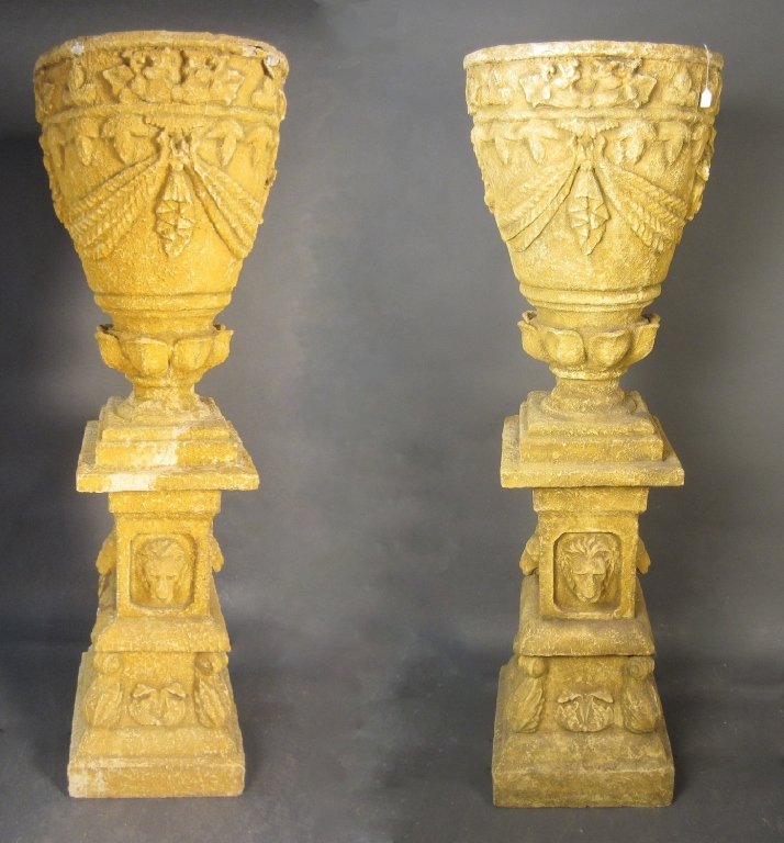 Pair of Tall Fiberglass Urns: Pair of tall fiberglass urns with ruff limestone appearance. some damages to both, one urn has large repairs. Height: 70 1/2", Width: 22"