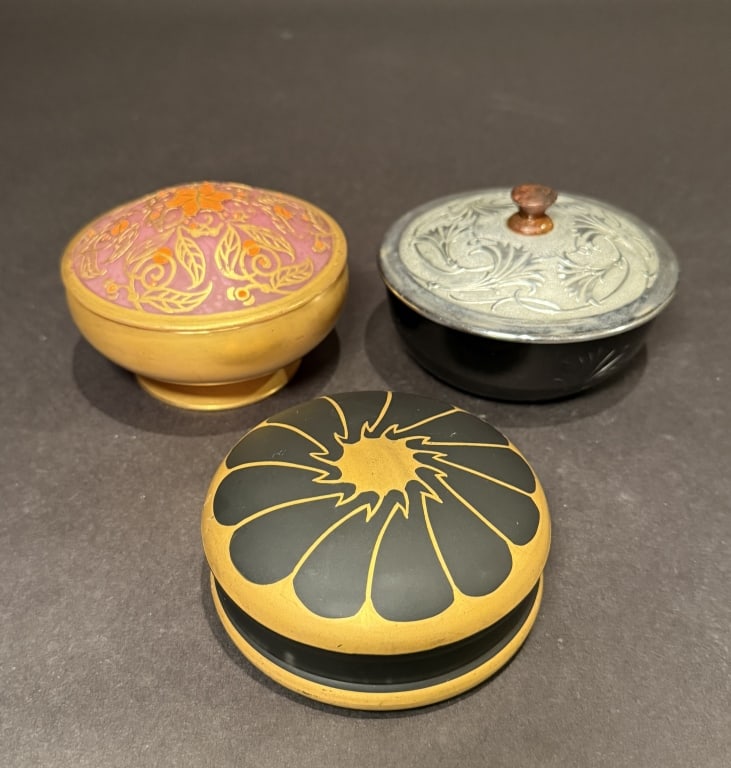 Collection Of 3 DeVilbiss Powder Boxes: Black and metal 4.75"x 3”. Black and gilt 4”x 2”. Lavender and gilt 4.5” x 3”. The Estate of the late Judy Boyd, New Jersey.STERLING ASSOCIATES STRIVES TO PROVIDE ACCURAT