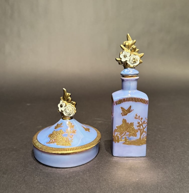 Noritake Perfume Bottle And Powder Box: Bottle height 6.6". Box 4" x 3.75". The Estate of the late Judy Boyd, New Jersey.STERLING ASSOCIATES STRIVES TO PROVIDE ACCURATE, OBJECTIVE, & FAIR INFORMATION ON ALL LOTS. WE WILL BE HAPPY TO ANSWER