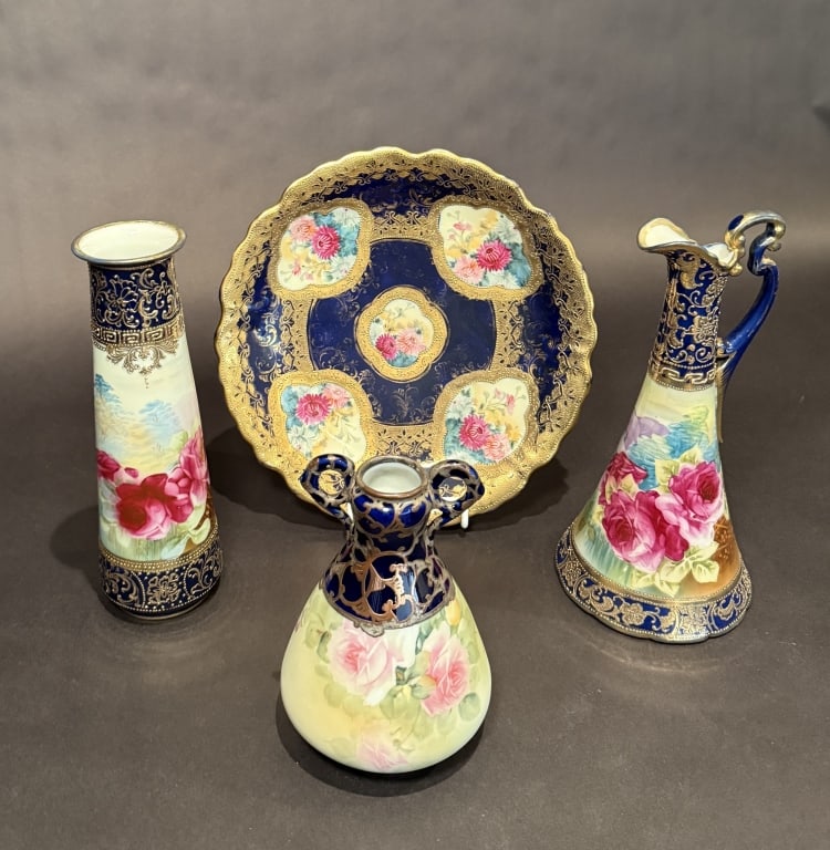Collection Of 4 Nippon Cobalt And Floral: Plate dia. 11". Small vase 7.5". Cylinder vase 10.5". Pitcher 11". The Estate of the late Judy Boyd, New Jersey.STERLING ASSOCIATES STRIVES TO PROVIDE ACCURATE, OBJECTIVE, & FAIR INFORMATION ON ALL LO