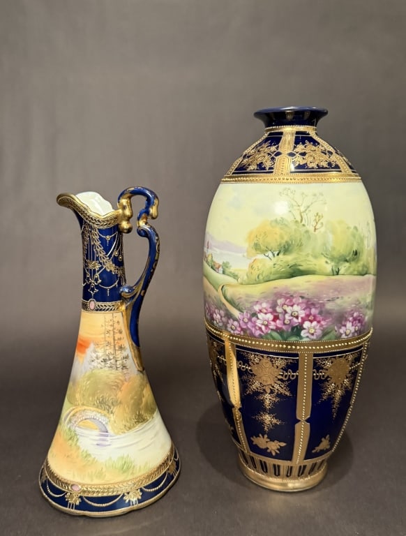 2 Nippon Gilt And Cobalt Scenic Vessels: Vase height 13.75". Pitcher height 11". The Estate of the late Judy Boyd, New Jersey.STERLING ASSOCIATES STRIVES TO PROVIDE ACCURATE, OBJECTIVE, & FAIR INFORMATION ON ALL LOTS. WE WILL BE HAPPY TO ANS