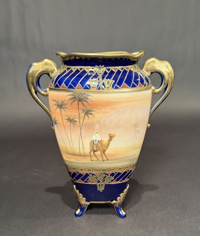 Nippon Cobalt And Gilt Scenic Vase: Nippon camel vase. Height 10". The Estate of the late Judy Boyd, New Jersey.STERLING ASSOCIATES STRIVES TO PROVIDE ACCURATE, OBJECTIVE, & FAIR INFORMATION ON ALL LOTS. WE WILL BE HAPPY TO ANSWER ANY Q