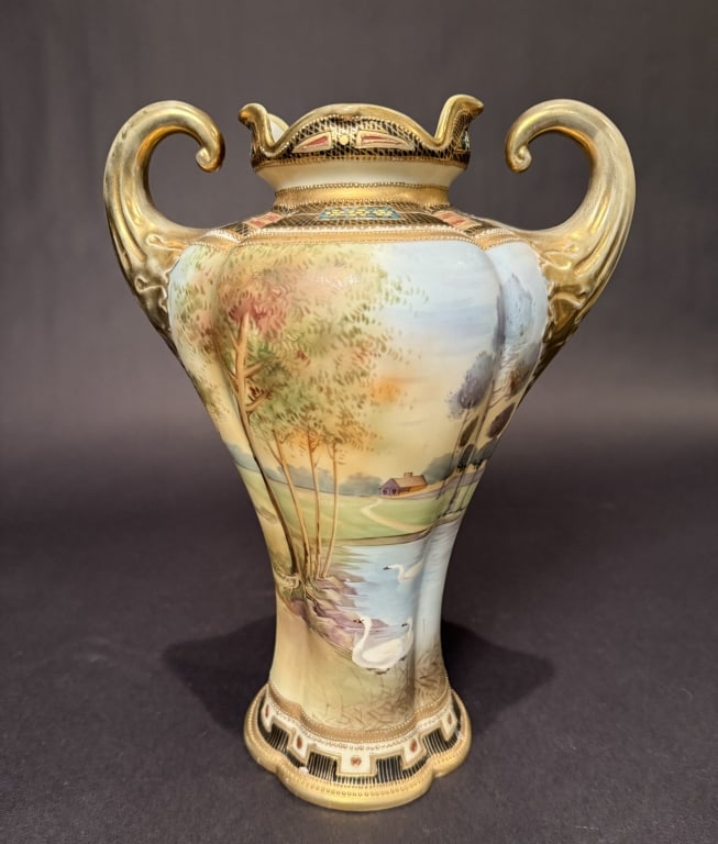 Nippon Double Handled Gilt Scenic Vase: Height 11". The Estate of the late Judy Boyd, New Jersey.STERLING ASSOCIATES STRIVES TO PROVIDE ACCURATE, OBJECTIVE, & FAIR INFORMATION ON ALL LOTS. WE WILL BE HAPPY TO ANSWER ANY QUESTIONS AND PROVID