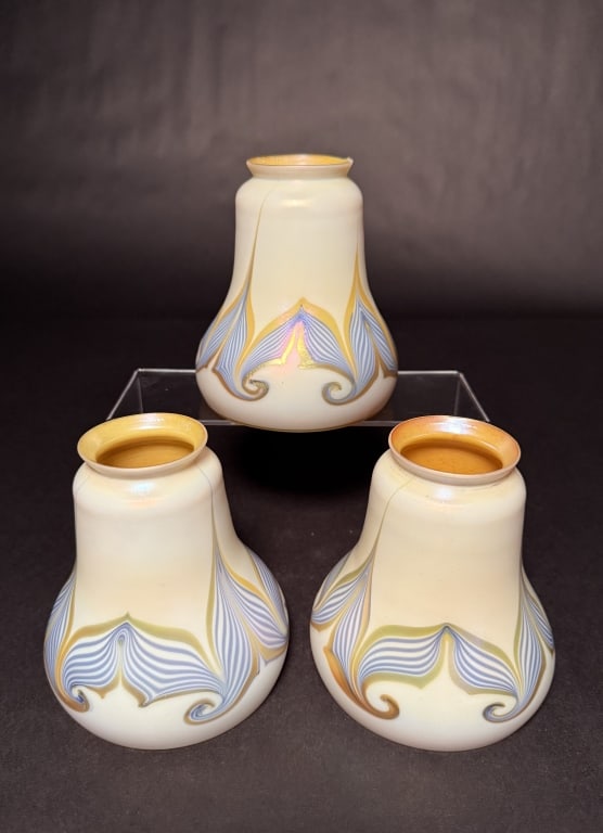 Set Of 3 Lustre Art Hooked Pulled Feather: Set of three Lustre Art blue and gold hooked pulled feather art glass shades with gold aurene interiors. 5 1/2" H. 4 3/8" Bottom opening. 2 1/4" Fitter. The Estate of the late Judy Boyd, New Jersey.ST
