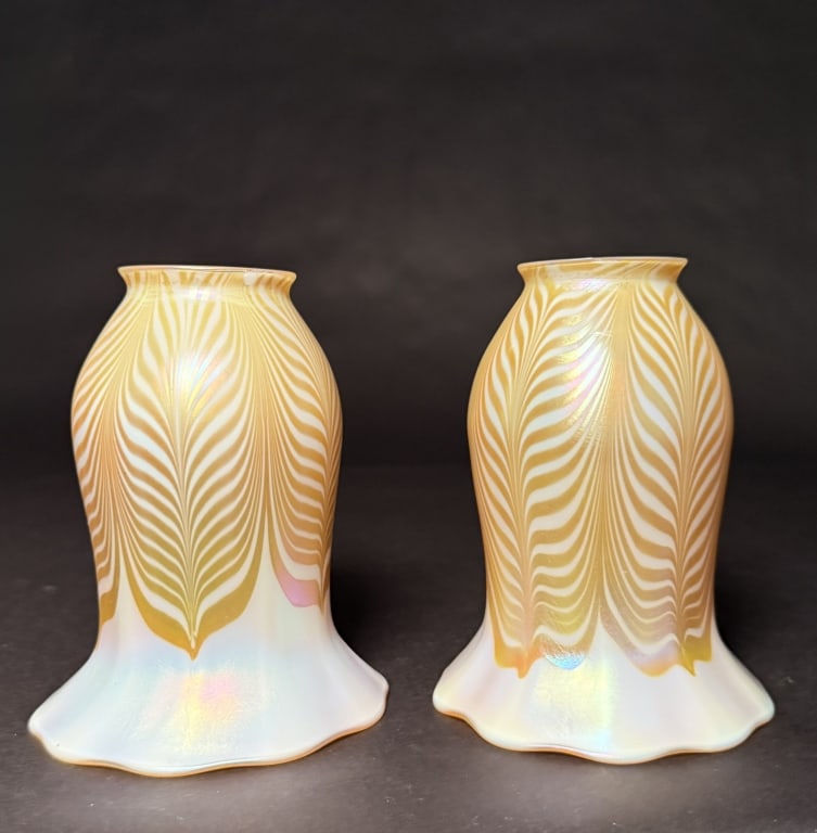 Pair Of Quezal Pulled Feather Shades: Pair Quezal of gold pulled feather art glass shades with gold aurene interiors. 6" H. 4 5/8" Bottom opening. 2 1/4" Fitter. The Estate of the late Judy Boyd, New Jersey.STERLING ASSOCIATES STRIVES TO 
