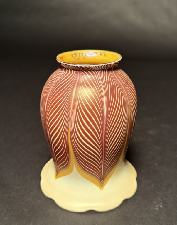 Quezal Selenium Red Pulled Feather Shade: Quezal pulled-feather selenium red tulip shade with crimped bottom and gold aurene interior.5 1/4" H. 4 1/8" Bottom opening. 2 1/4" Fitter. The Estate of the late Judy Boyd, New Jersey.STERLING ASSOCI