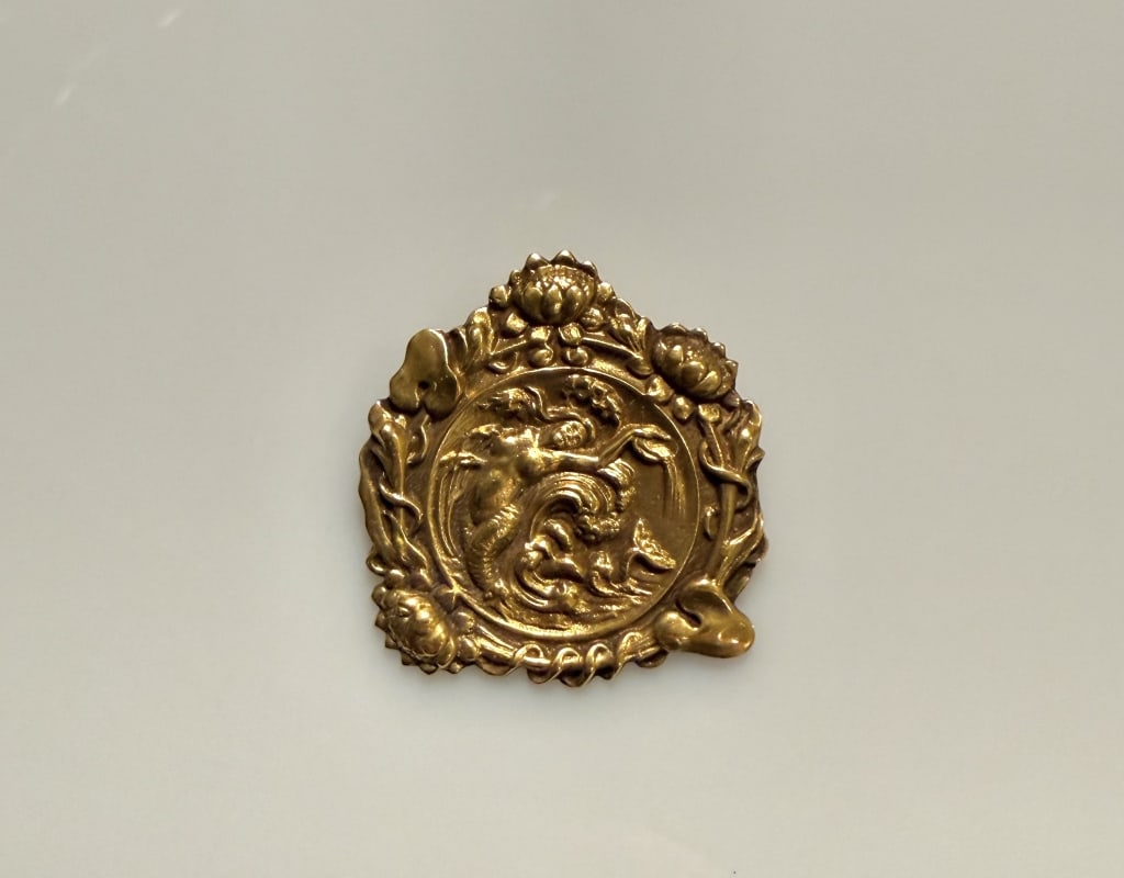 14K Gold Art nouveau pendant With Mermaid: Approx. dimensions1 1/4" x 1 1/8". Tested 14K. Approx. gross weight 13.1 grams. STERLING ASSOCIATES STRIVES TO PROVIDE ACCURATE, OBJECTIVE, & FAIR INFORMATION ONALL LOTS. WE WILL BE HAPPY TO ANSWER AN