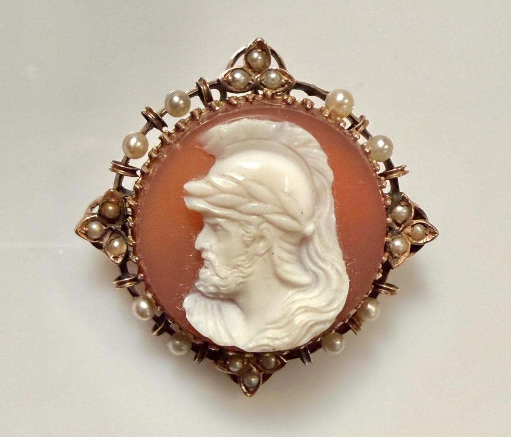 14K Gold And Pearl Cameo Brooch Pin: Approx. dimensions 1" x 1". Tested 14K. Approx. gross weight 8.4 grams. STERLING ASSOCIATES STRIVES TO PROVIDEACCURATE, OBJECTIVE, & FAIR INFORMATION ON ALL LOTS. WE WILL BE HAPPY TO ANSWER ANY QUESTI