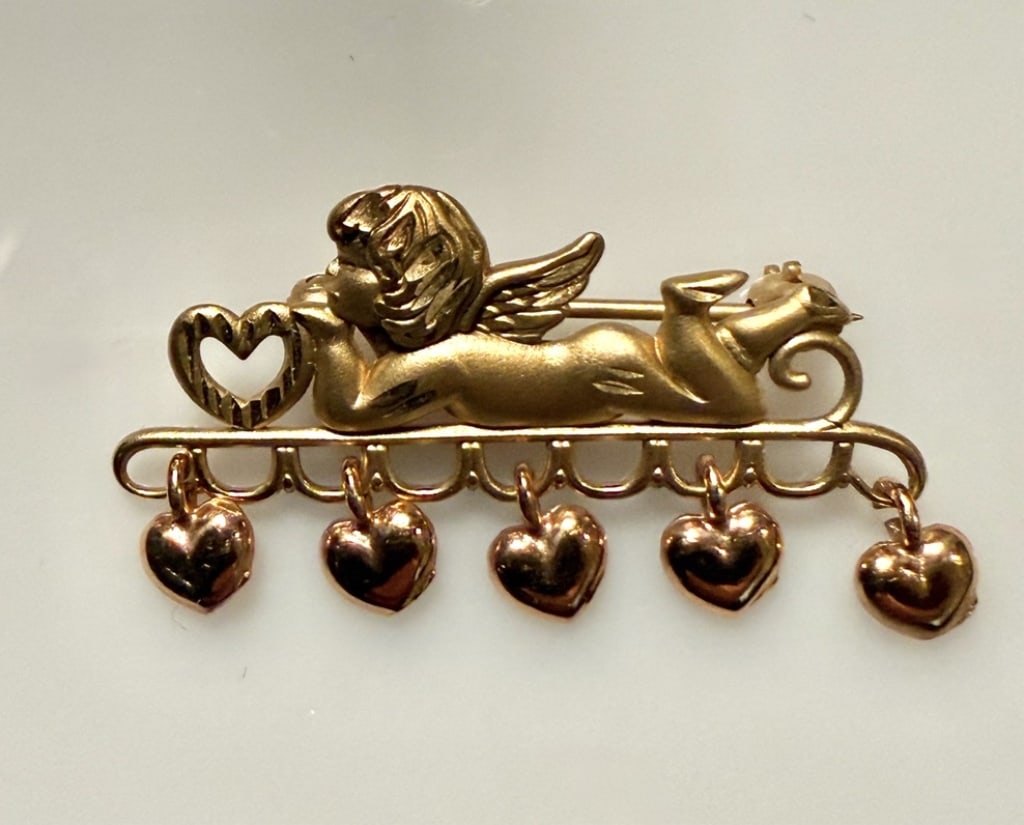 14K Gold Cupid And Heart Form Brooch Pin: Approx. dimensions 1" x 1/2". Marked 14K. Approx. gross weight 2.5 grams. STERLING ASSOCIATES STRIVES TO PROVIDEACCURATE, OBJECTIVE, & FAIR INFORMATION ON ALL LOTS. WE WILL BE HAPPY TO ANSWER ANY QUES