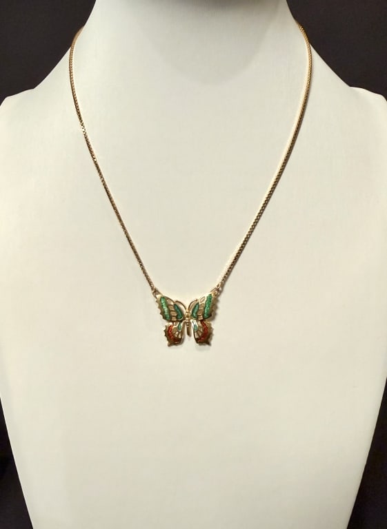 18K Gold And Enamel Butterfly Pendant On Chain: Approx. dimensions chain 14". 1" x 7/8" pendant Marked 18K. Approx. gross weight 6.7 grams.STERLING ASSOCIATES STRIVES TO PROVIDE ACCURATE, OBJECTIVE, & FAIR INFORMATION ON ALL LOTS. WE WILL BE HAPPY 