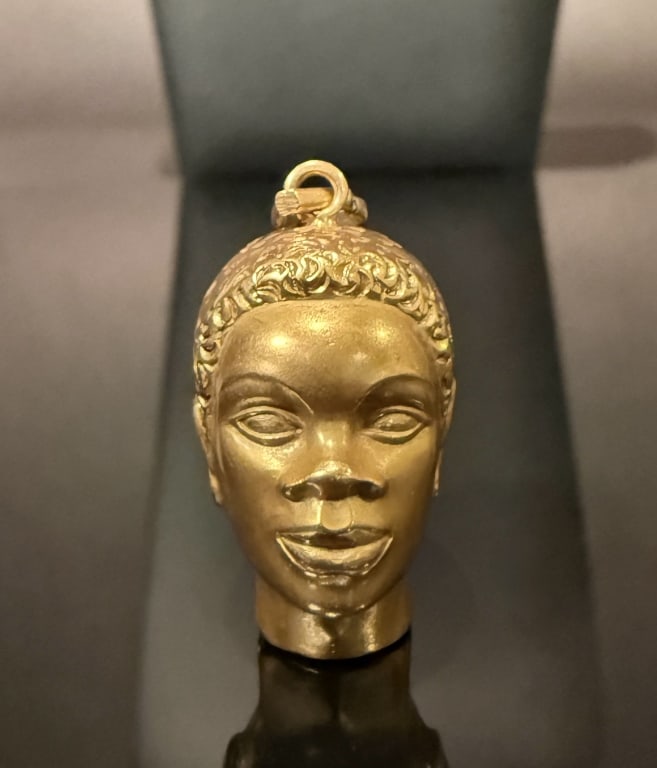 18K Gold Blackamoor Pendant: Approx. dimensions 1 1/4" x 1". Marked Italy18K. Approx. gross weight 7.2 grams. STERLING ASSOCIATES STRIVES TO PROVIDEACCURATE, OBJECTIVE, & FAIR INFORMATION ON ALL LOTS. WE WILL BE HAPPY TO ANSWER A