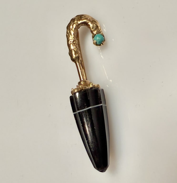 14K Gold And Agate Umbrella Form Stickpin: Approx. dimensions 1 3/4" x 1/2". Tested 14K. Approx. gross weight 4.9 grams. STERLING ASSOCIATES STRIVES TO PROVIDEACCURATE, OBJECTIVE, & FAIR INFORMATION ON ALL LOTS. WE WILL BE HAPPY TO ANSWER ANY