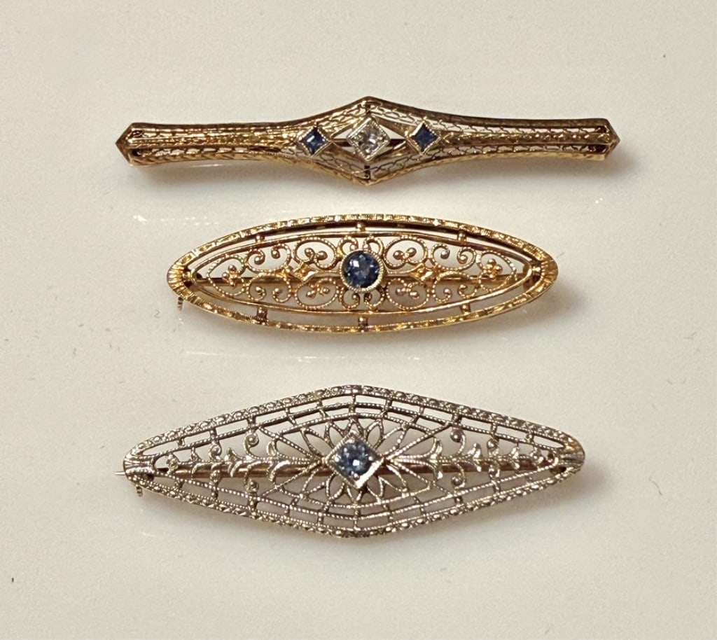14K Gold Edwardian Style Brooch Pins (3): Yellow and white gold. Approx. dimensions 2" x 3/8" longest. Marked 14K. Approx. gross weight 8.9 grams.STERLING ASSOCIATES STRIVES TO PROVIDE ACCURATE, OBJECTIVE, & FAIR INFORMATION ON ALL LOTS. WE W