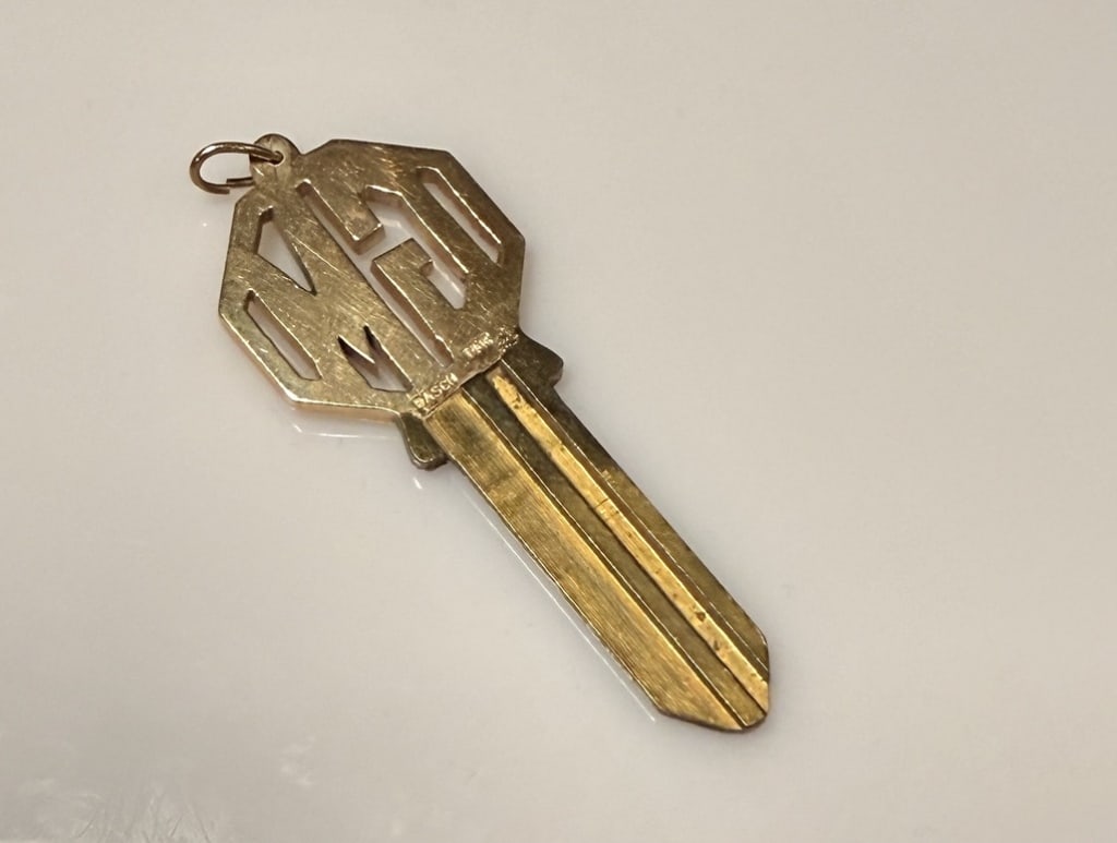 14K Gold Key Top Cut Out "GM": Approx. dimensions 7/8" x 2". Marked Basch 14K. Approx. gross weight 9.3 grams. STERLING ASSOCIATES STRIVES TO PROVIDEACCURATE, OBJECTIVE, & FAIR INFORMATION ON ALL LOTS. WE WILL BE HAPPY TO ANSWER AN