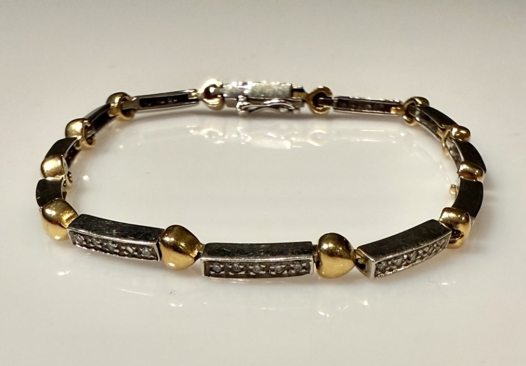 18K White And Yellow Gold And Diamond Bracelet: Approx. dimensions 7"length. Marked 18K. Approx. gross weight 12.6 grams. STERLING ASSOCIATES STRIVES TO PROVIDEACCURATE, OBJECTIVE, & FAIR INFORMATION ON ALL LOTS. WE WILL BE HAPPY TO ANSWER ANY QUES
