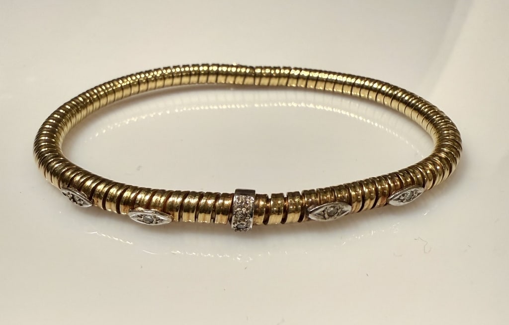 18K Gold And Diamond Tubogas Bracelet: Approx. dimensions 7 1/2" length. Tested 18K. Approx. gross weight 17.0 grams. STERLING ASSOCIATES STRIVES TO PROVIDEACCURATE, OBJECTIVE, & FAIR INFORMATION ON ALL LOTS. WE WILL BE HAPPY TO ANSWER ANY