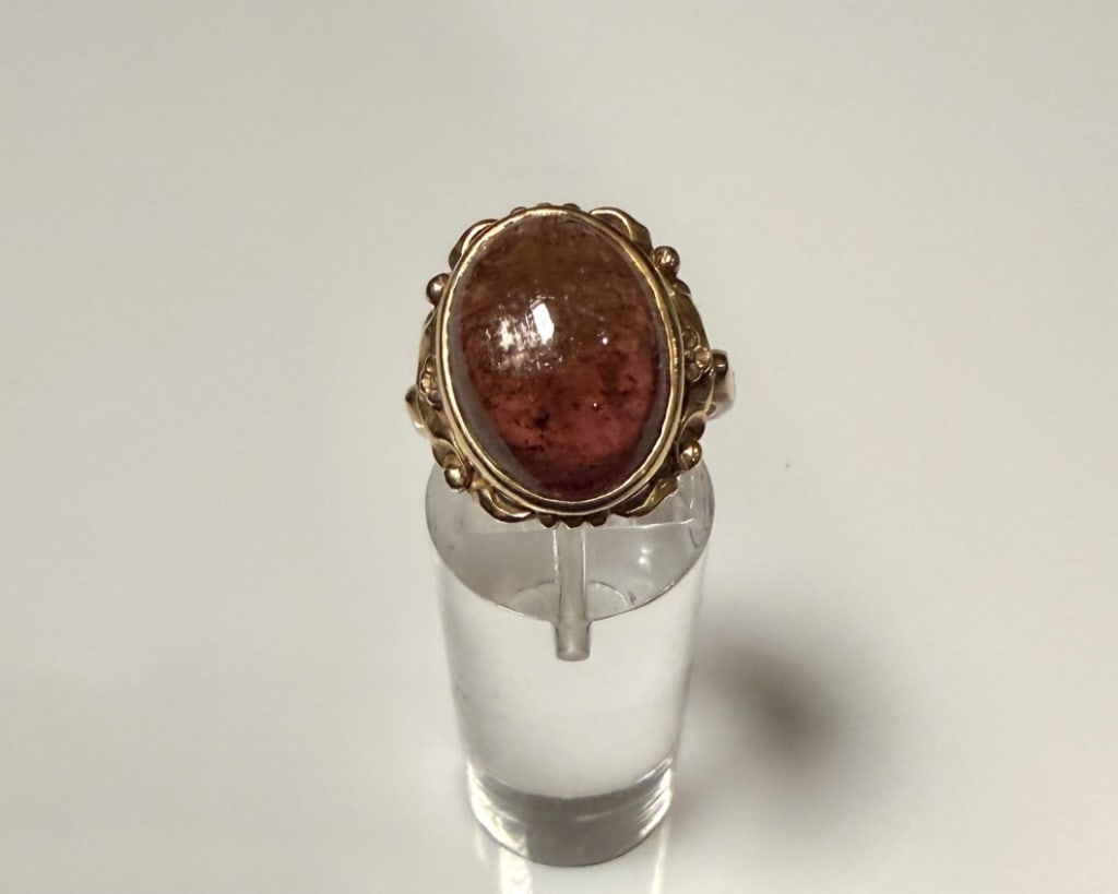 14K Gold And Pink Tourmaline Ring: Ring size 6. Marked 14K Approx. gross weight 6.0 grams.STERLING ASSOCIATES STRIVES TO PROVIDE ACCURATE, OBJECTIVE, & FAIR INFORMATION ON ALL LOTS. WE WILL BE HAPPY TO ANSWER ANY QUESTIONS AND PROVIDE