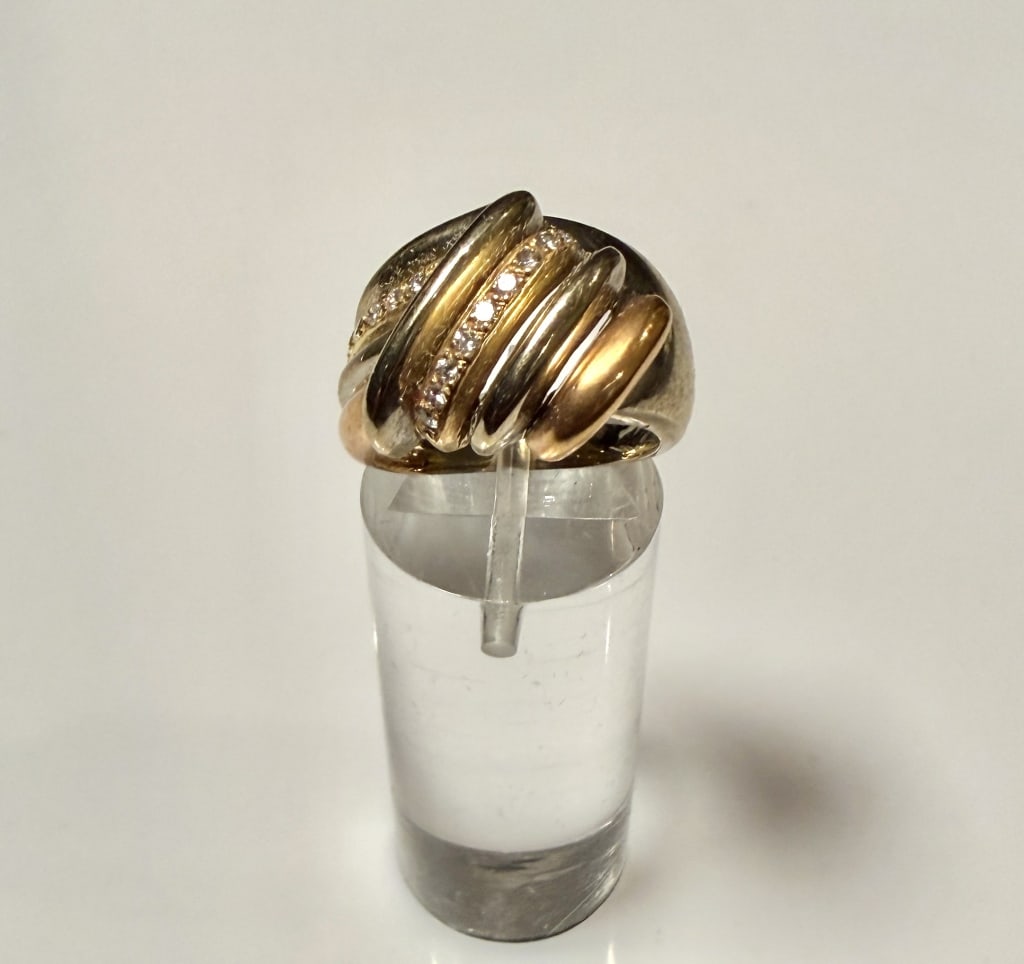 18K Two Tone Gold And Diamond Ring: Ring size 5 1/4. Marked 18K. Approx. gross weight 10.9 grams. STERLING ASSOCIATES STRIVES TO PROVIDE ACCURATE, OBJECTIVE, & FAIR INFORMATION ONALL LOTS. WE WILL BE HAPPY TO ANSWER ANY QUESTIONS AND PR