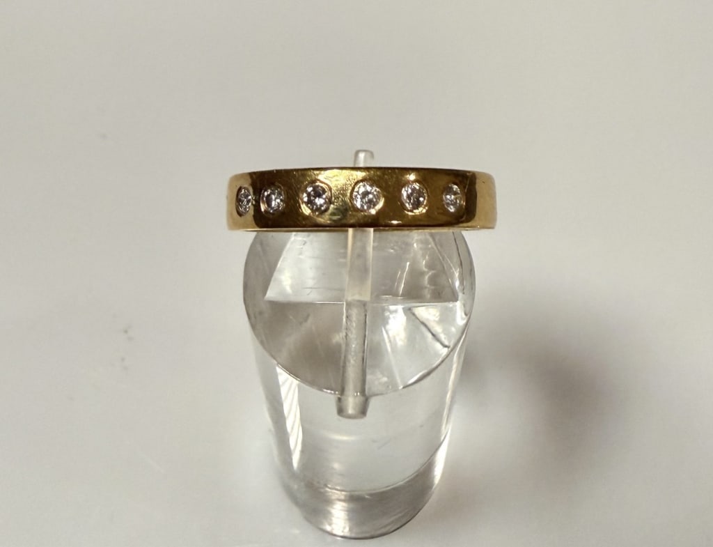 18k Gold And Diamond Tiffany & Co. Wedding Band: Ring size 7 3/4. Marked 18K Tiffany & Co. Approx. gross weight 4.7 grams. STERLING ASSOCIATES STRIVES TO PROVIDE ACCURATE, OBJECTIVE, & FAIR INFORMATION ONALL LOTS. WE WILL BE HAPPY TO ANSWER ANY QUES