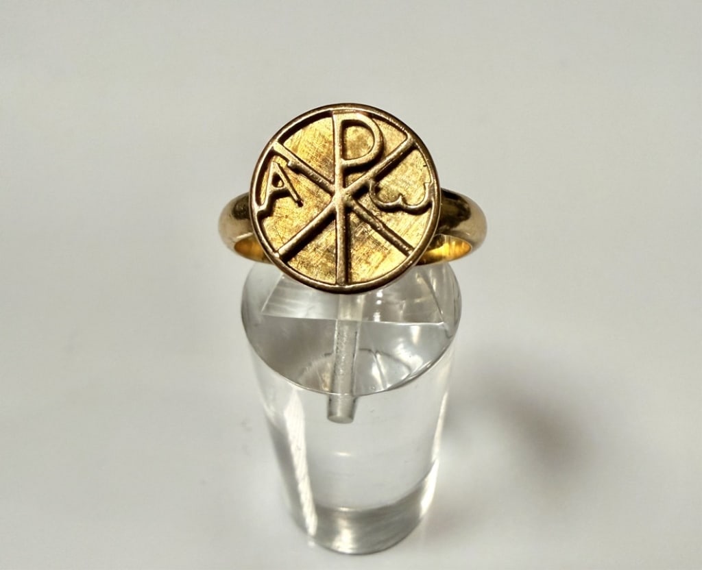 18K Gold Chi-Rho Signet Ring: Ring size 6 3/4. Tested 18K. Approx. gross weight 4.4 grams. STERLING ASSOCIATES STRIVES TO PROVIDEACCURATE, OBJECTIVE, & FAIR INFORMATION ON ALL LOTS. WE WILL BE HAPPY TO ANSWER ANY QUESTIONS AND PRO