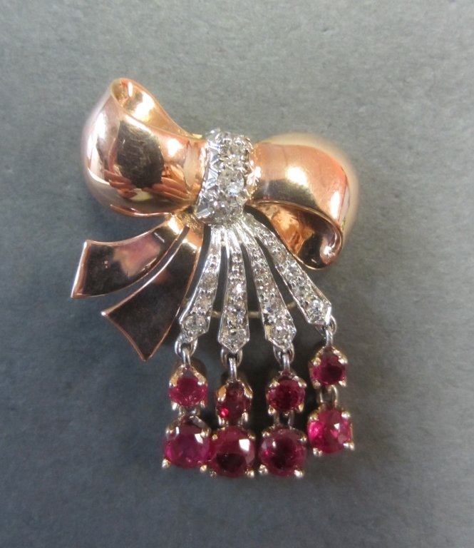 14 Kt Pin w/ Diamonds & Rubies: 14Kt pin in the form of a bow w/ diamonds and rubies. Height: 1" approx total weight 5 grams
