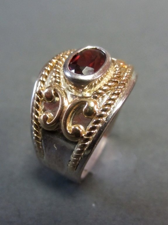 Sterling and 14Kt Ring: Sterling & 14Kt, and possible garnet ring.