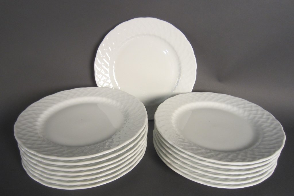 14 Porcelain Dinner Plates: From the estate of John McDonald Set of 14 white porcelain plates with maker's mark on bottom. Basket weave design around edge of plate