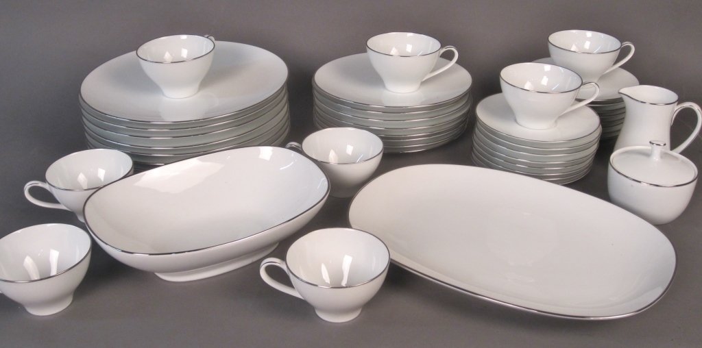 Noritake Porcelain Dinnerware, Service for 8: Noritake Japan dinnerware service for 8, along with matching creamer, sugar bowl, and 2 serving pieces. Pieces are white porcelain with silvered rims. Maker's mark on bottom.