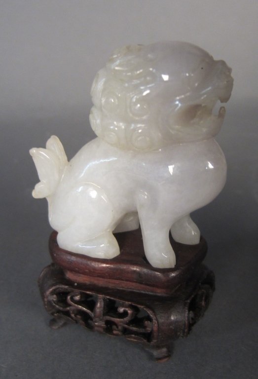 Jade Carving on Wood Base: Jade carving of foo dog on carved wood base