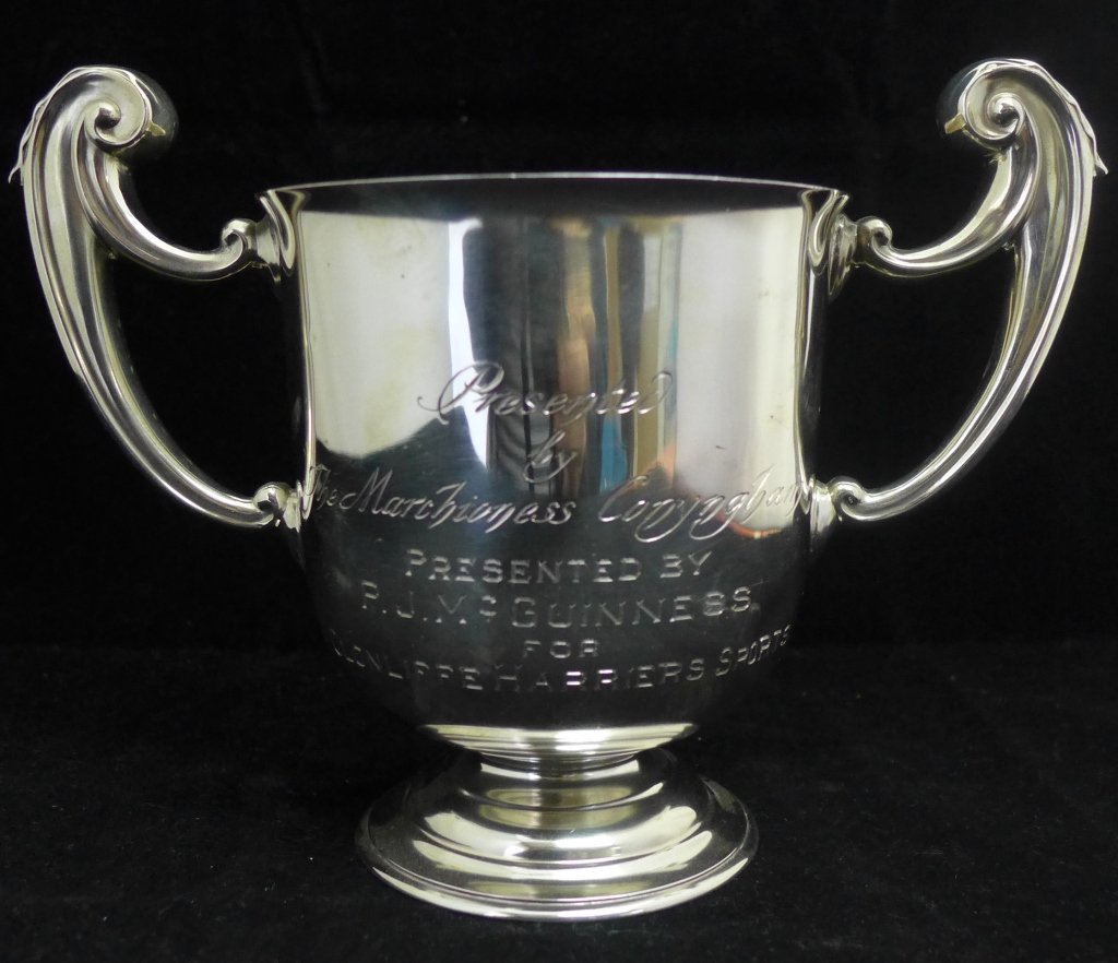 Sterling Silver Trophy: Sterling silver engraved Guinness trophy with hallmarks on top, just below rim and on bottom. 1 noticeable dent and a few scratches. Height: 5 5/8", Width: 8". Approx weight: 359 grams.