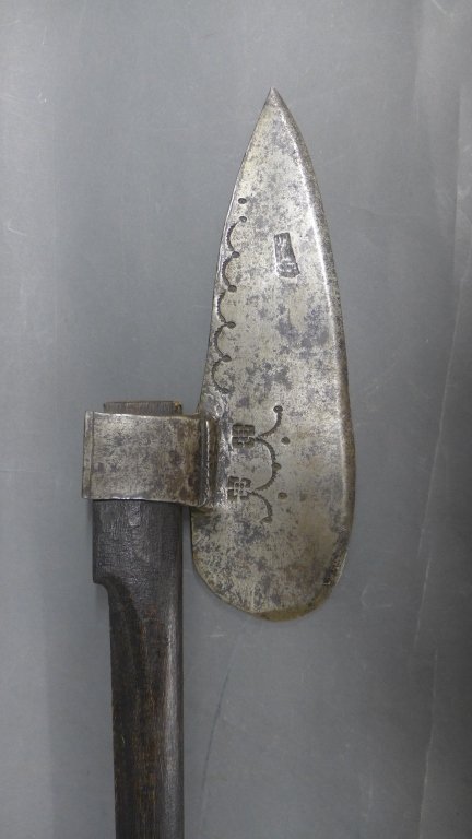 Doloire, 17th Century: The doloire or wagoner's axe was a tool and weapon used during the Middle Ages and Renaissance. This doloire is dates to the 17th Century. One side of blade is marked/ impressed with a scalloped desig